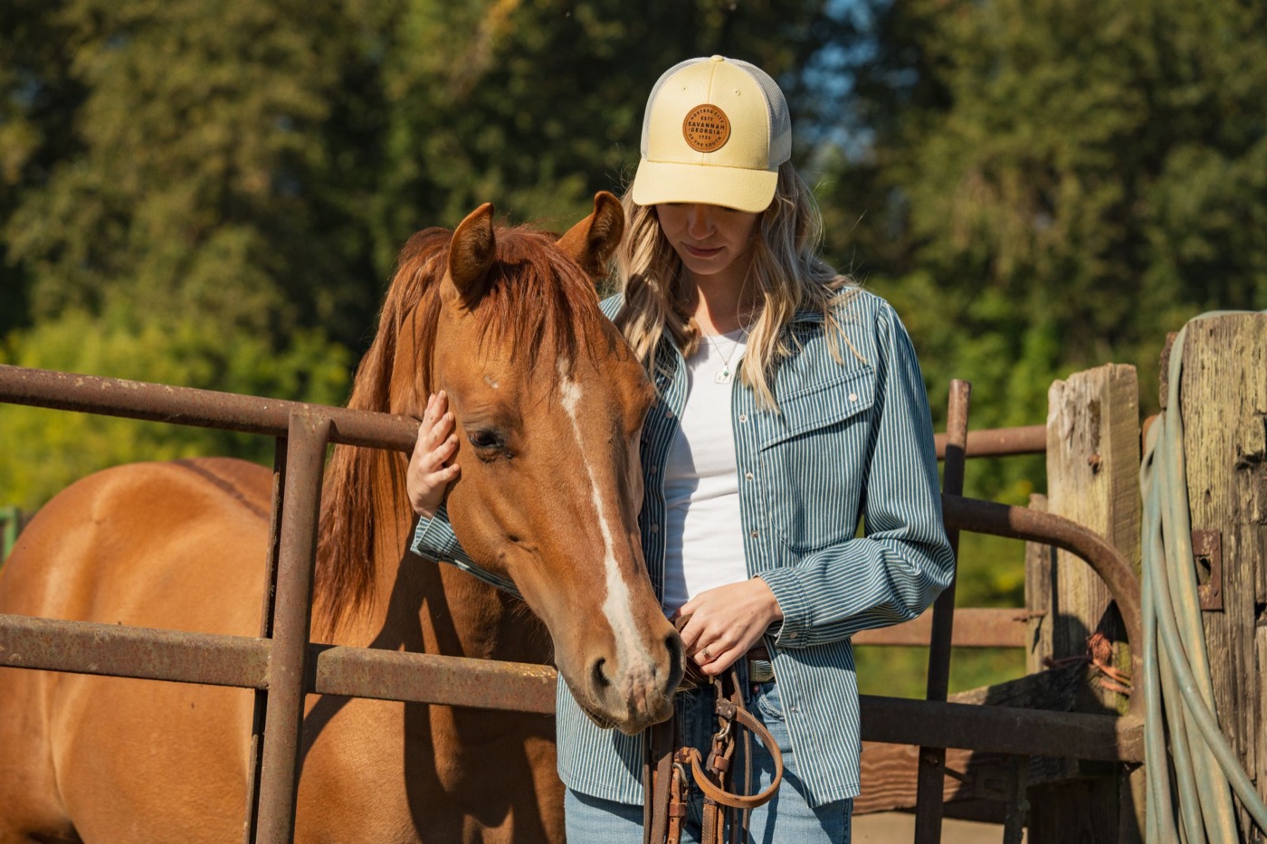 Model in a Savannah Georgia patch cap with a chestnut horse
