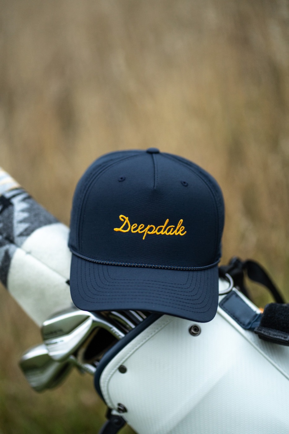 Deepdale cap resting on a golf bag