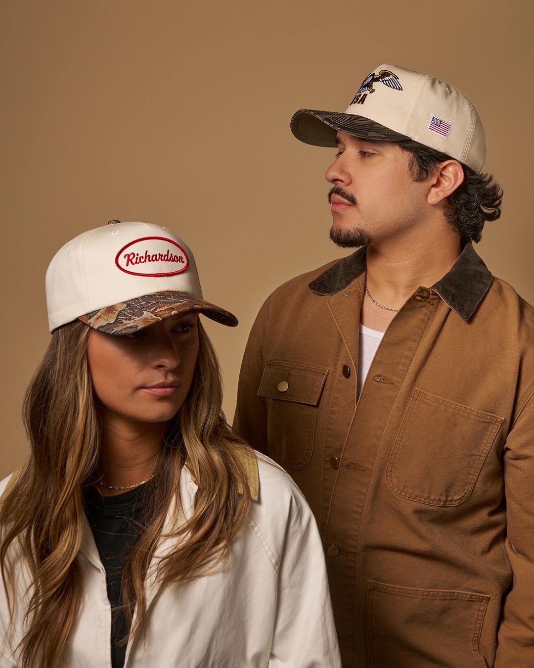 Two models in cream caps with camo brims