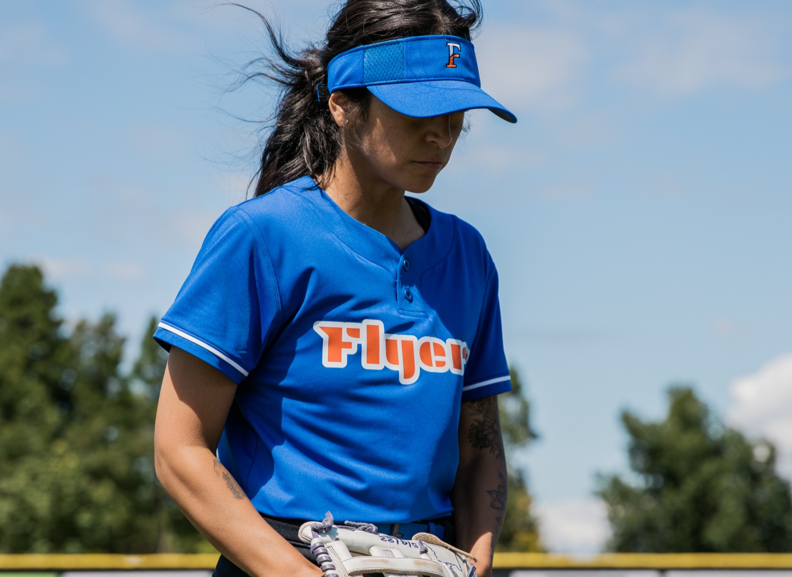 Softball player in a Flyers jersey and visor